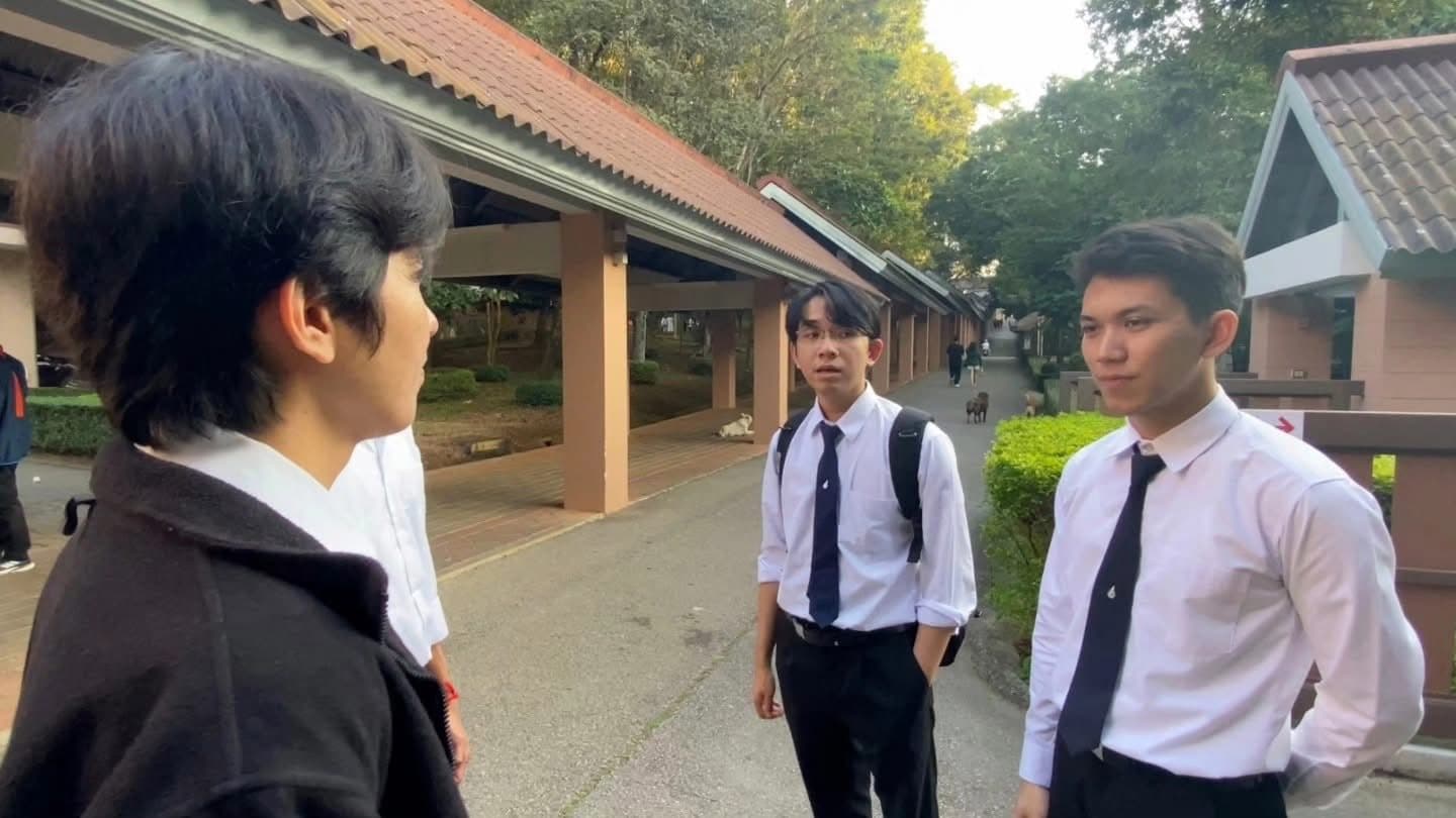 Buk in a school project video with classmates on campus